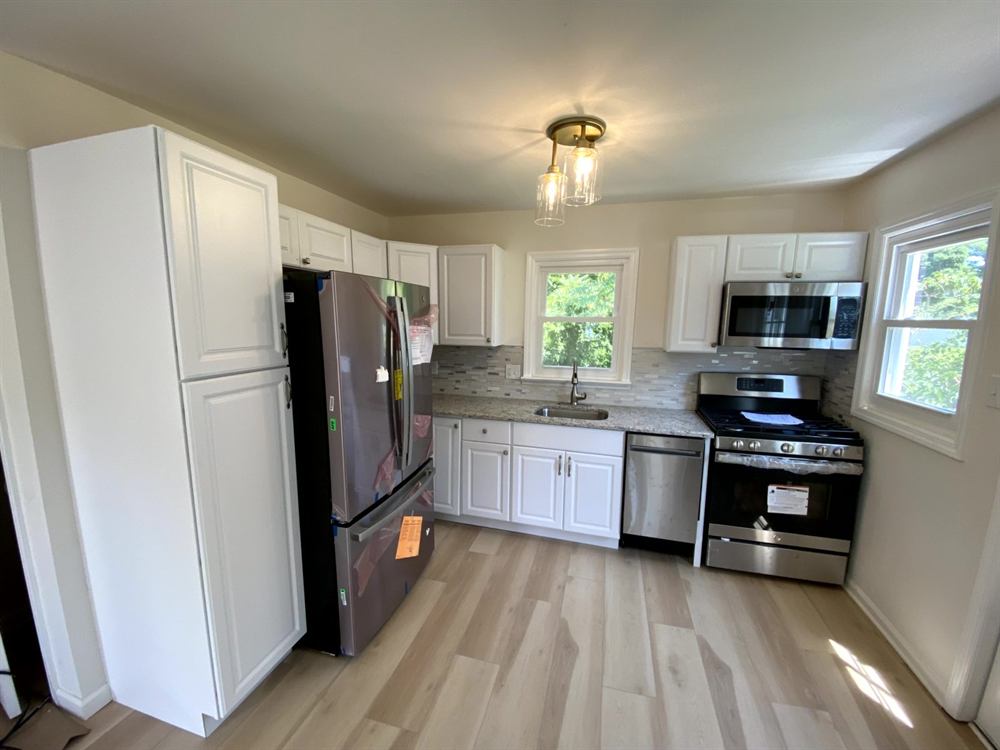 contemporary kitchen layout with open floor plan and integrated appliances